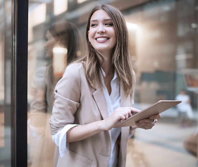 A female holding a tablet in the office.